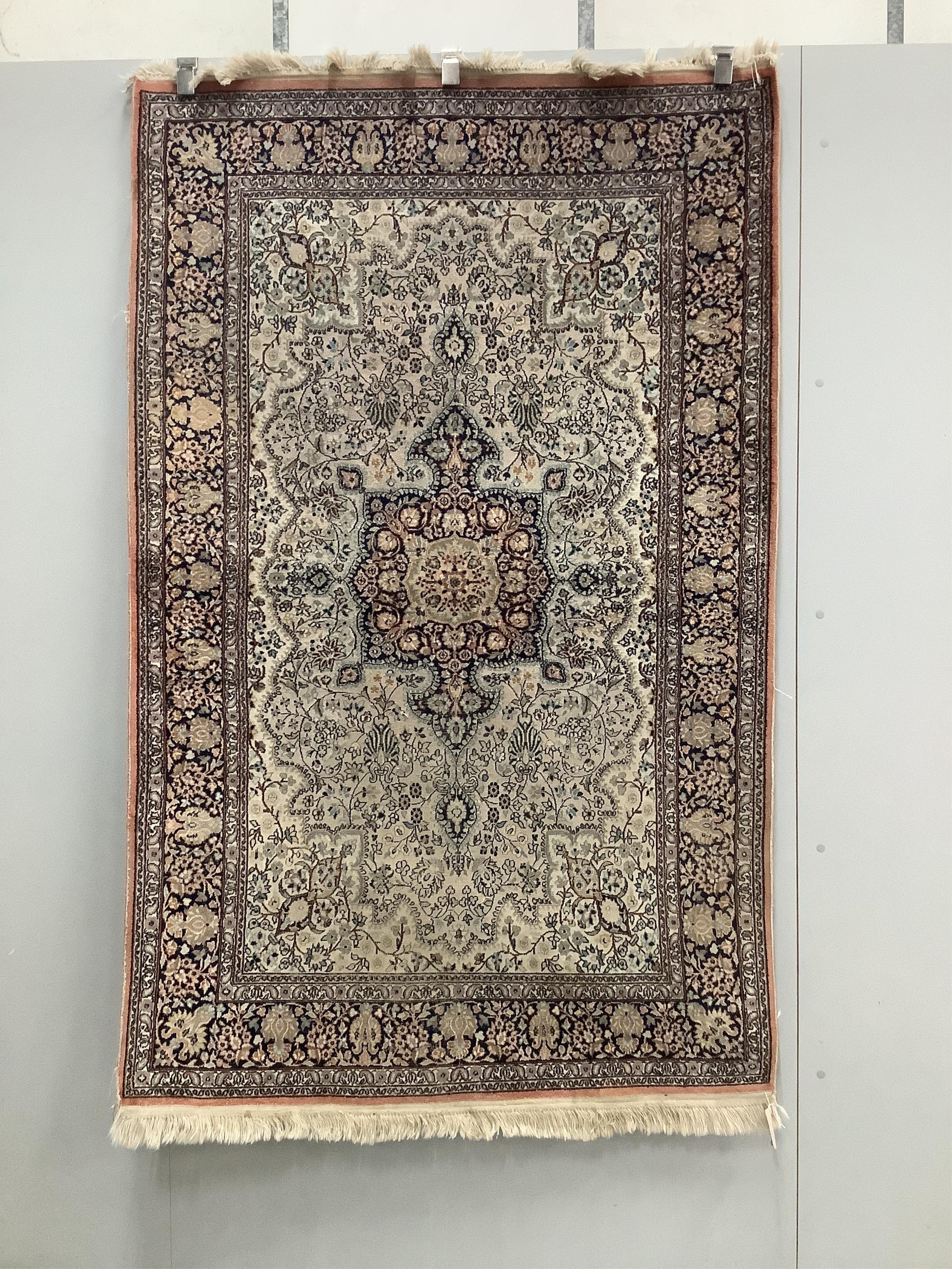 An Indian ivory ground rug, 190 x 121cm. Condition - poor